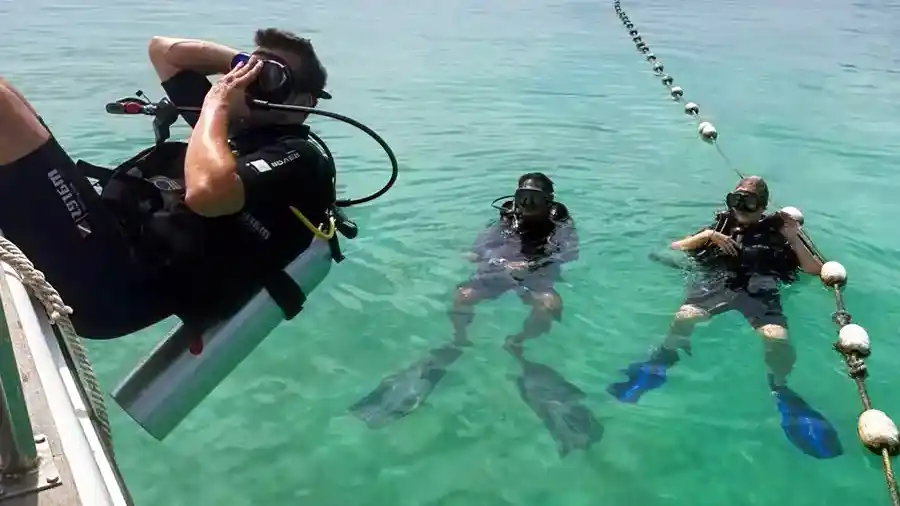 Two divers preparing for a dive session at Mabul Island Jelly Sea Resort