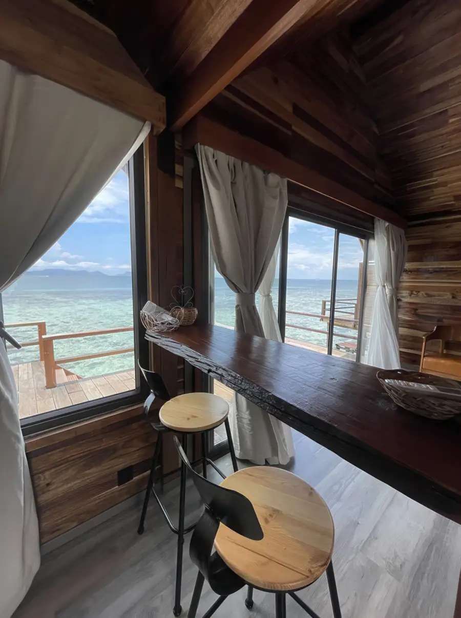 A charming room at Jelly Sea Resort near Bum Bum Island with a live-edge wooden bar and traditional style wood paneling, featuring grey wood-textured floors and air conditioning.