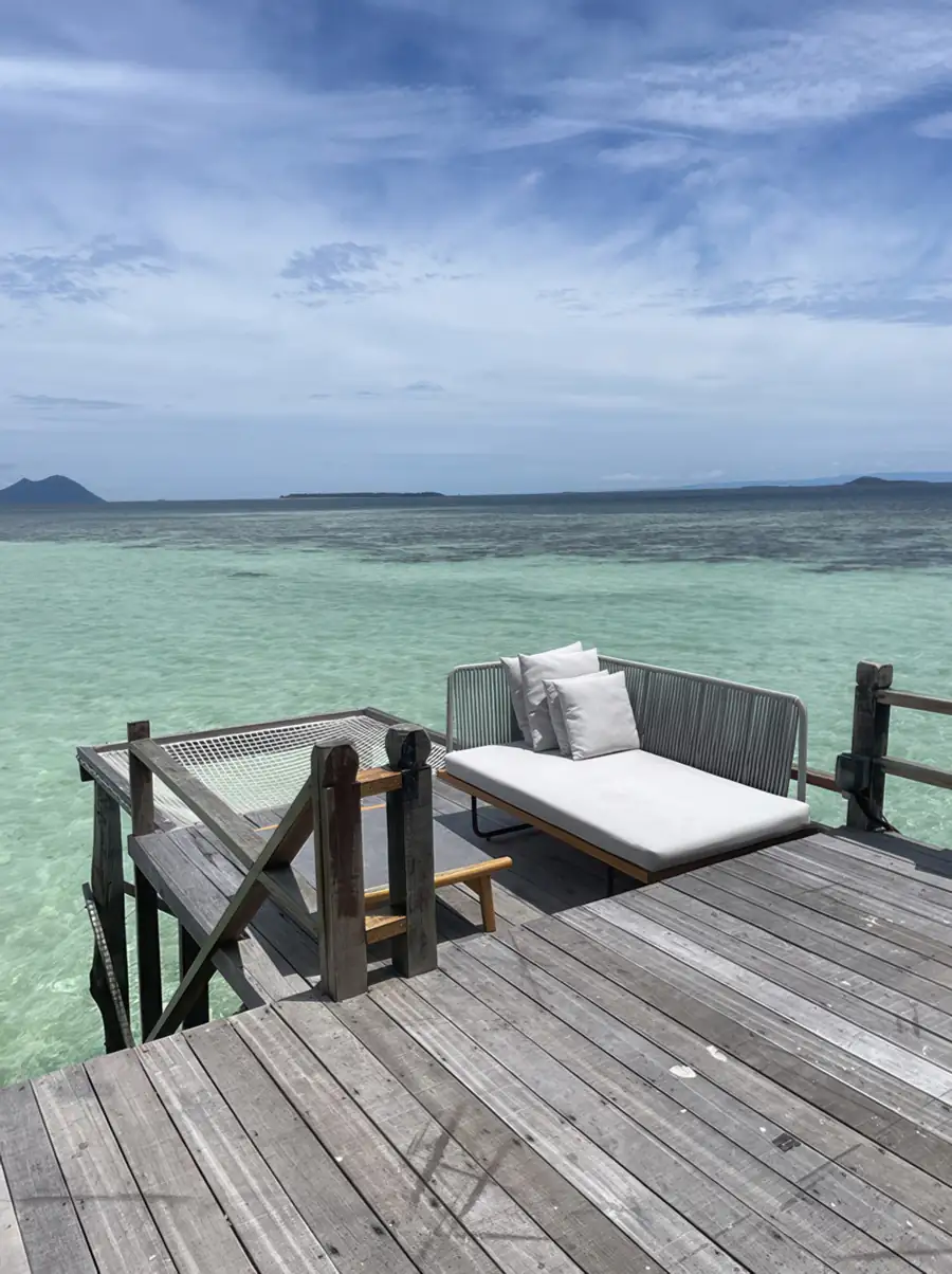 Direct access wooden stairs leading into the ocean at Jelly Sea Resort. A romantic floating paradise perfectly positioned for a refreshing swim near Bohey Dulang.